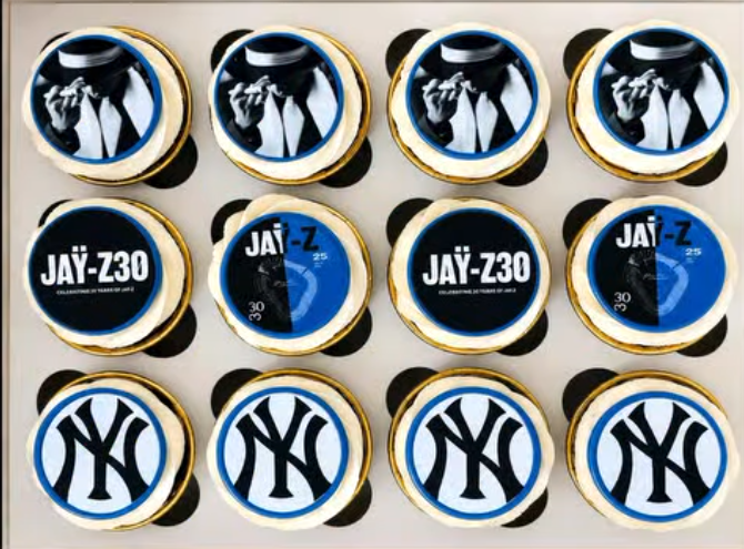 A dozen cupcakes with custom anniversary toppers